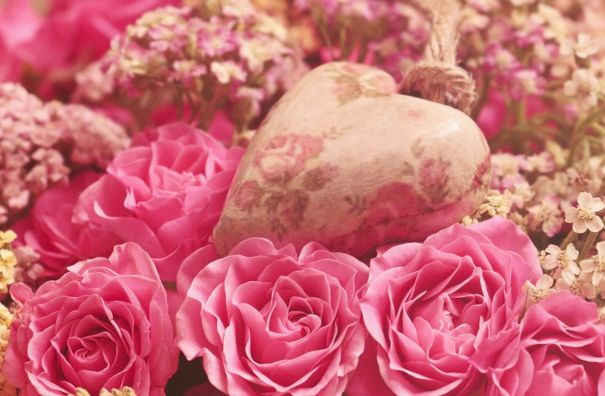 Bridal bouquet in ivory and blush held against a dress