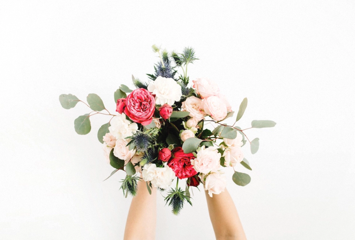 Bright birthday bouquet wrapped in kraft paper with ribbon